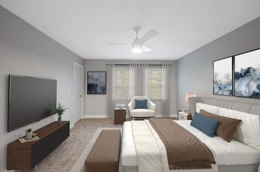 a master bedroom with a large bed and a ceiling fan at Indian Creek Apartments*, Cincinnati, OH