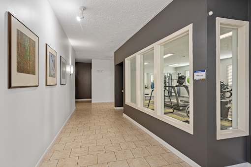 a resident fitness center with mirrors on the wall and a tiled floor at DeSales Flats Apartments*, Ohio, 45206