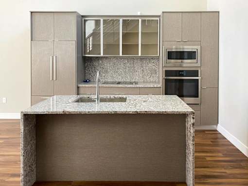 A kitchen with a granite countertop and a sink.at Sky Central, Cincinnati, 45202