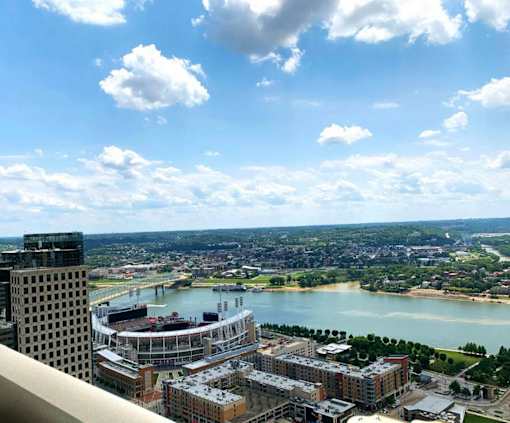 A cityscape with a river and a bridge in the distance at Sky Central, Cincinnati, OH