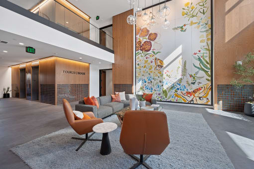 a lobby with a couch and chairs in front of a large window at Four23/Hoge, Ohio, 45226