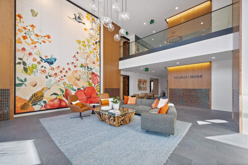 a lobby with a couch and a table in front of a wall with flowers at Four23/Hoge, Ohio