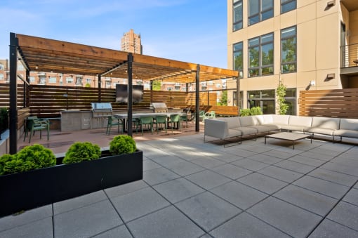 a patio with couches and tables and a bar and a building at Four23/Hoge, Cincinnati, OH, 45226