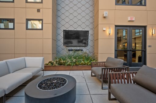a lounge area with couches and chairs and a fire pit at Four23/Hoge, Ohio