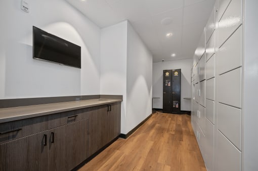 a long hallway with white walls and wooden floors and a white refrigerator and a door at Four23/Hoge, Ohio, 45226