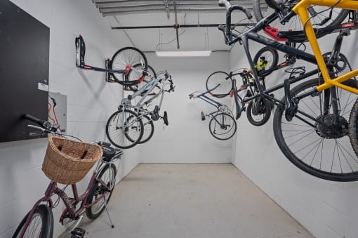 a bike room with many bikes hanging on the wall at Four23/Hoge, Cincinnati