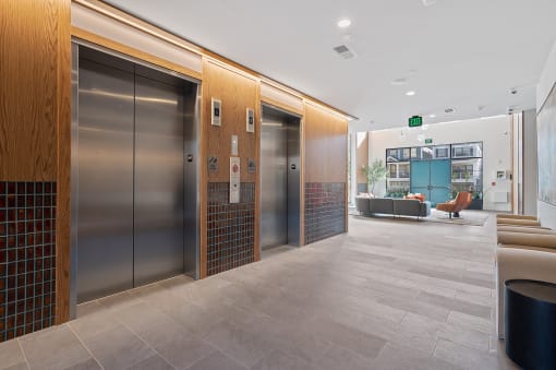 a lobby with elevators and a seating area and a staircase at Four23/Hoge, Ohio