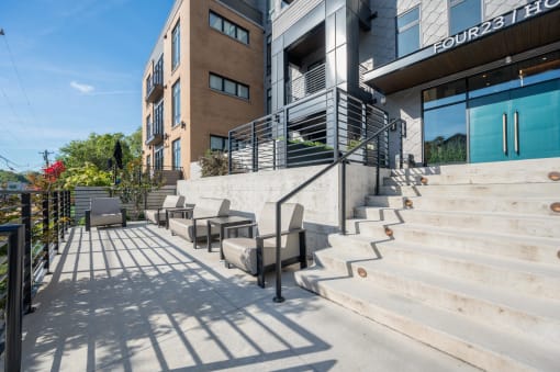 a patio with stairs and chairs next to a building at Four23/Hoge, Ohio