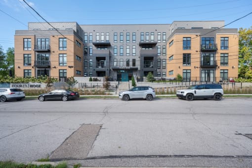 a city street with cars parked in front of an apartment building at Four23/Hoge, Cincinnati, Ohio