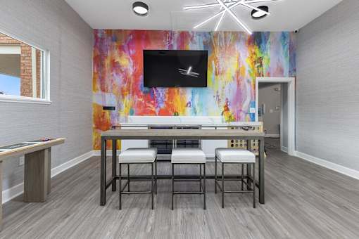 a dining room with a table and chairs and a tv at Indian Lookout Apartments, Ohio