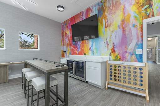 a break room with a table and chairs and a television at Indian Lookout Apartments, West Carrollton, 45449