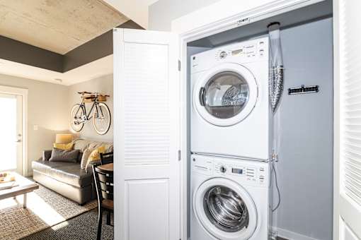 A white washing machine and dryer in a laundry room.