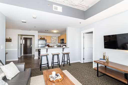 A modern living room with a bar area and a television.