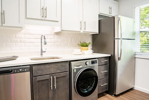 a kitchen with white cabinets and stainless steel appliances at Ten31, Dayton, Ohio