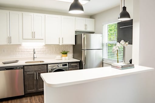 a kitchen with white cabinets and stainless steel appliances at Ten31, Dayton, OH, 45458