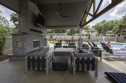 a patio with a fireplace and lounge chairs at Olde Towne in Kenwood, Ohio