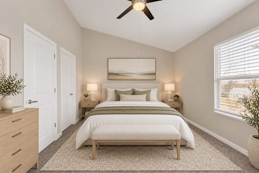 A bedroom with a bed, nightstands, and a ceiling fan.