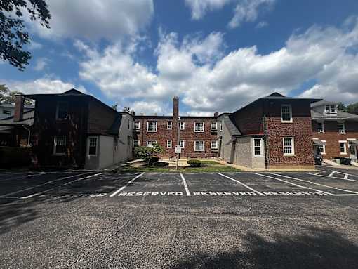 an empty parking lot in front of a brick building  at Cincinnati Premier Living*, Cincinnati, Ohio