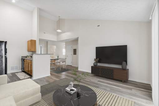 A modern living room with a black sofa and a television.