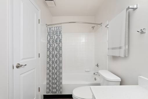 A white bathroom with a toilet, sink, and shower.at Crooked Creek, Indiana, 46268