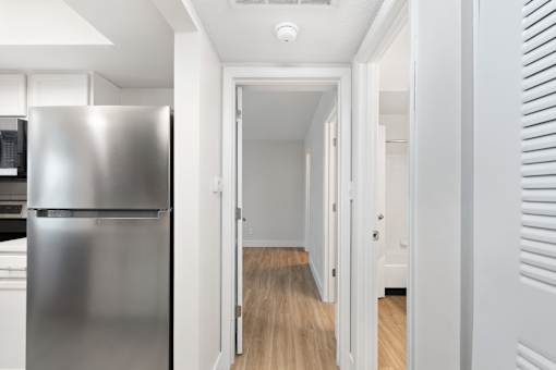 A long hallway with a refrigerator on the left.at Crooked Creek, Indiana, 46268