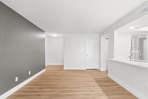 A long, empty room with wooden floors and white walls.at Crooked Creek, Indianapolis, IN