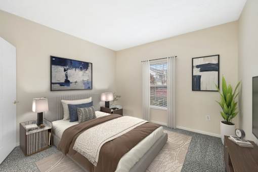 A bedroom with a large bed and a painting on the wall.