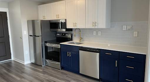 A kitchen with a stainless steel refrigerator, oven, and dishwasher.