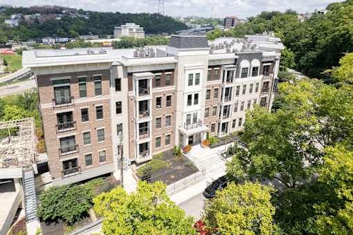 A large multi-story building with a parking lot in front.