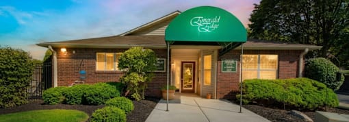 The front of a building with a green awning that says "Riverdale".