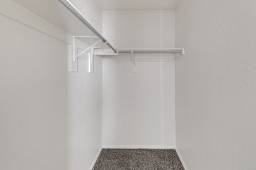 A white room with a grey carpet and a white ceiling.