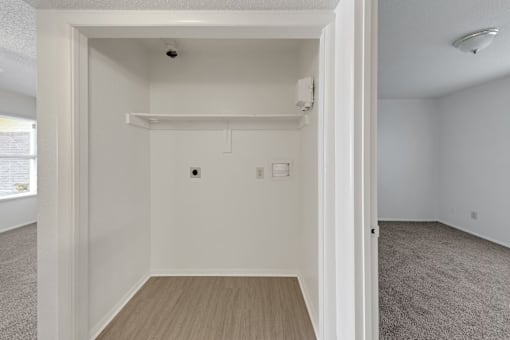 A white room with a doorway leading to another room.