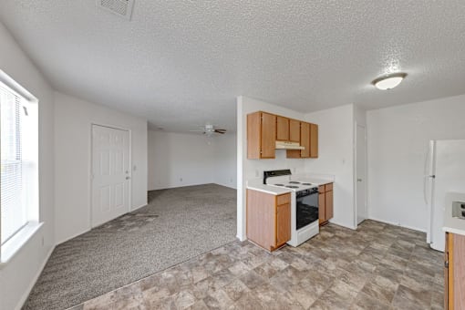 A kitchen area with a stove top oven and a refrigerator.