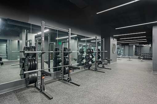 A gym with a variety of weightlifting equipment at Sky Central Apartments, Ohio