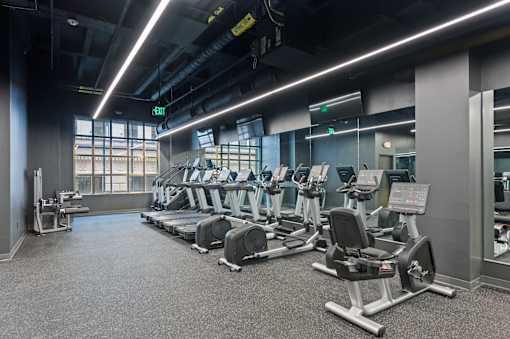 A gym with treadmills and elliptical machines at Sky Central Apartments, Cincinnati, OH, 45202