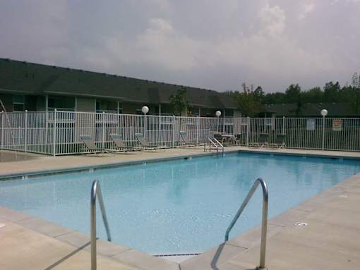 A swimming pool surrounded by a metal fence.