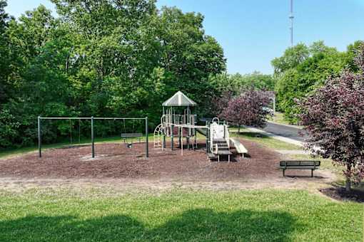 A playground with a swing set and a slide.