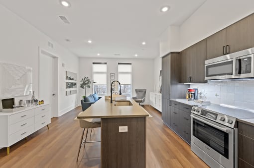 Kitchen with a large center island with a sink and a stove top oven at Four23/Hoge, Cincinnati, OH