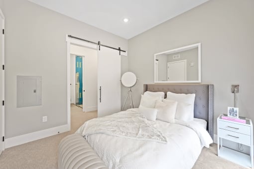Bedroom with a large bed and white walls at Four23/Hoge, Cincinnati, OH