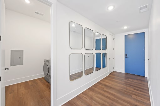 Laundry room with white walls and a blue door at Four23/Hoge, Ohio