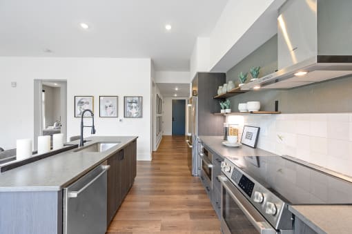 Kitchen with stainless steel appliances and a wooden floor at Four23/Hoge, Cincinnati, OH, 45226