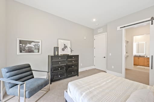 Bedroom with a bed and a chair in front of a dresser at Four23/Hoge, Ohio, 45226