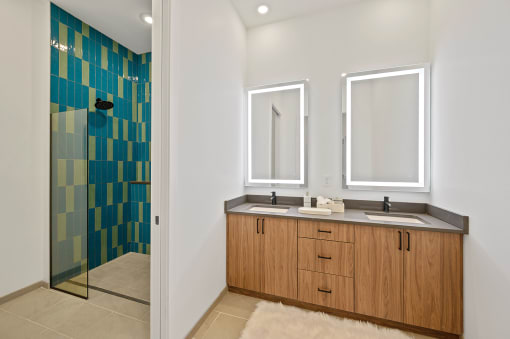 Bathroom with two sinks and a shower with a glass door at Four23/Hoge, Cincinnati, OH, 45226