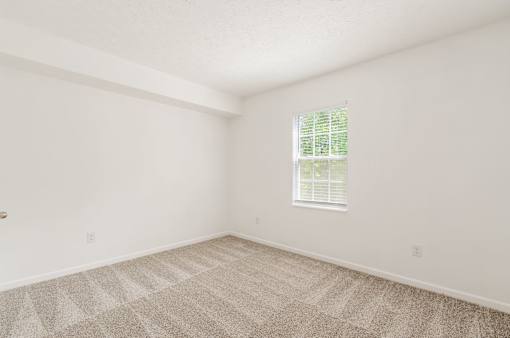 an empty room with carpet and a window at Prescott Place, Columbus, 43235