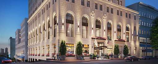 A large, elegant building with many windows and balconies is shown at Sky Central Apartments, Cincinnati, Ohio