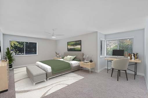 A bedroom with a bed, desk, and chair.