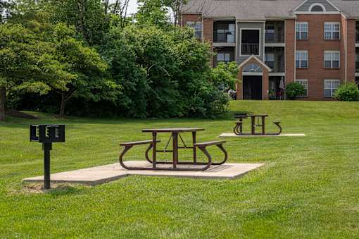 Picnic tables in a park in front of an apartment building at Indian Lookout, West Carrollton, OH, 45449