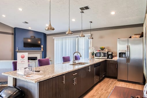 A kitchen with a counter and a refrigerator.