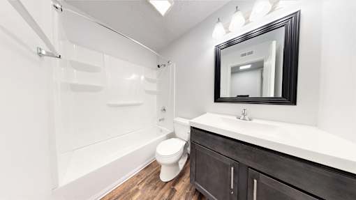 a bathroom with a toilet sink and bathtub at Lawrence Landing, Indiana, 46226