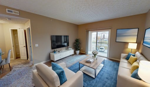 a living room with a couch and a table and a television at Prescott Place, Columbus, OH, 43235